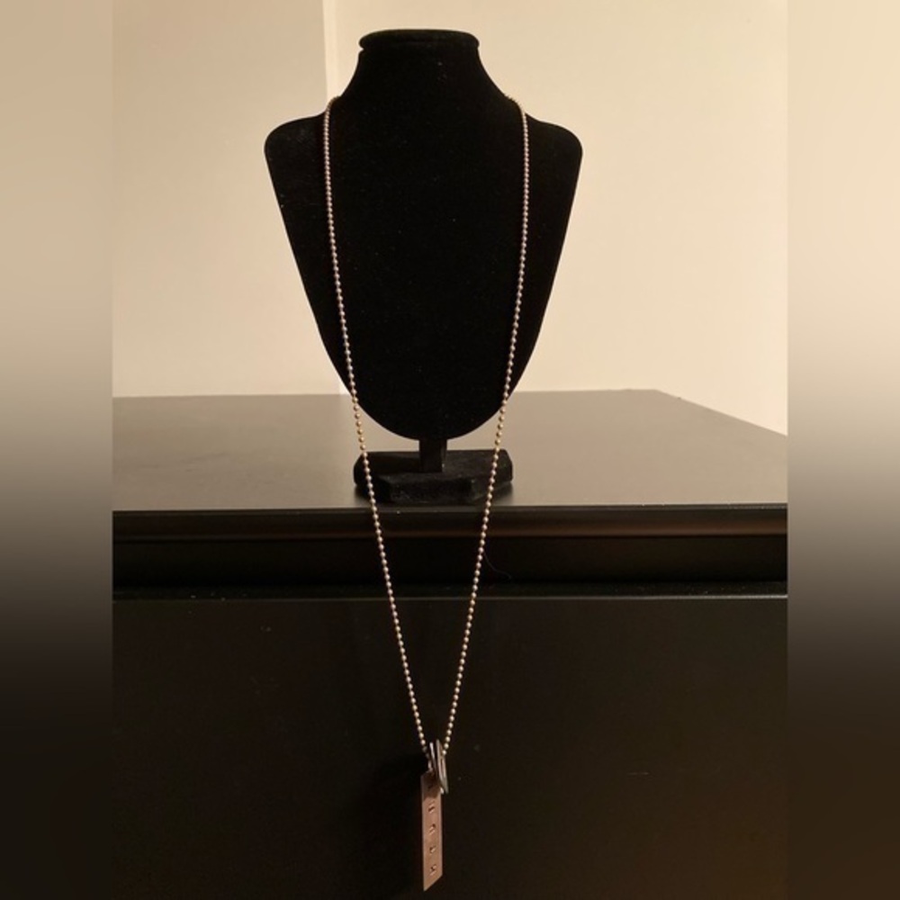 Very long necklace with “Truth” pendant